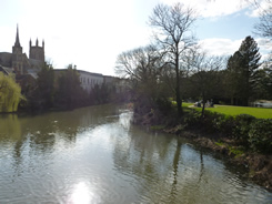 View from suspension bridge looking down the river Leam. St Marys church on left hand side, with Jephson Gardens to the right.